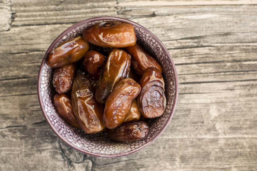 bowl-of-dates-on-wood-597071467-5aa04f0ec6733500377d1a4d