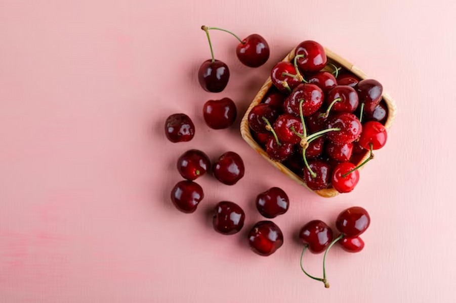 cherries-wooden-plate-pink-surface_176474-6324
