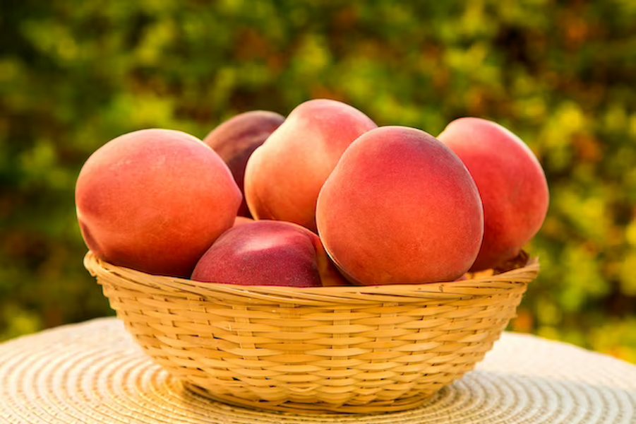 some-peaches-basket-wooden-surface-fresh-fruits_70216-2578